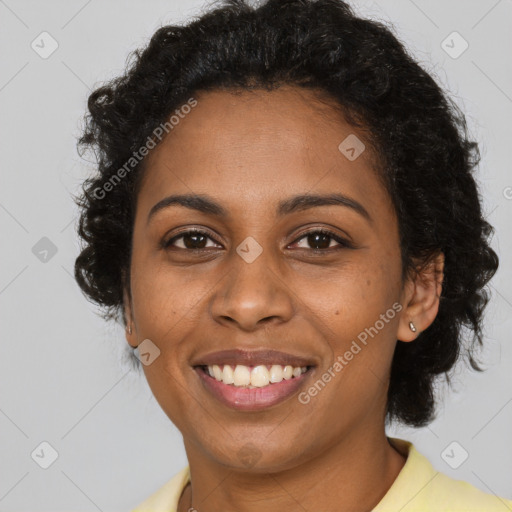 Joyful black young-adult female with long  brown hair and brown eyes