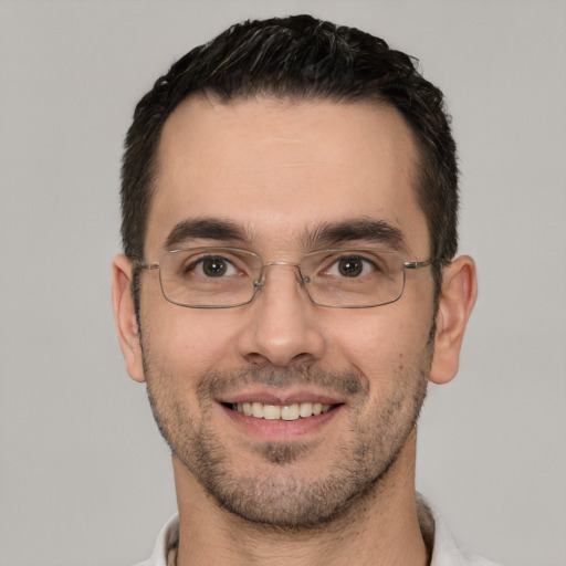 Joyful white young-adult male with short  black hair and brown eyes