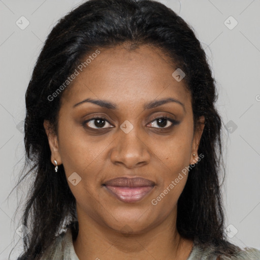 Joyful black adult female with long  black hair and brown eyes