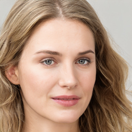 Joyful white young-adult female with long  brown hair and blue eyes