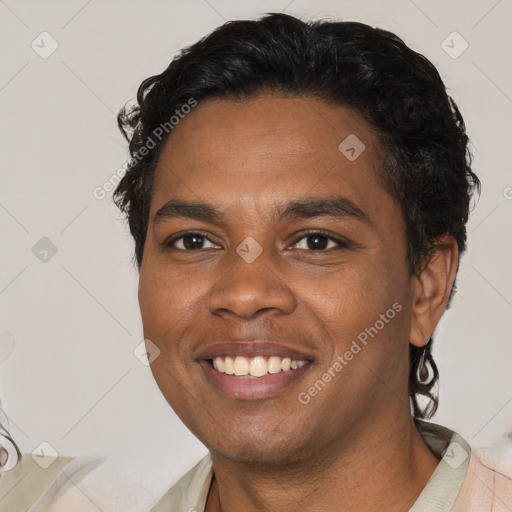 Joyful black young-adult male with short  black hair and brown eyes