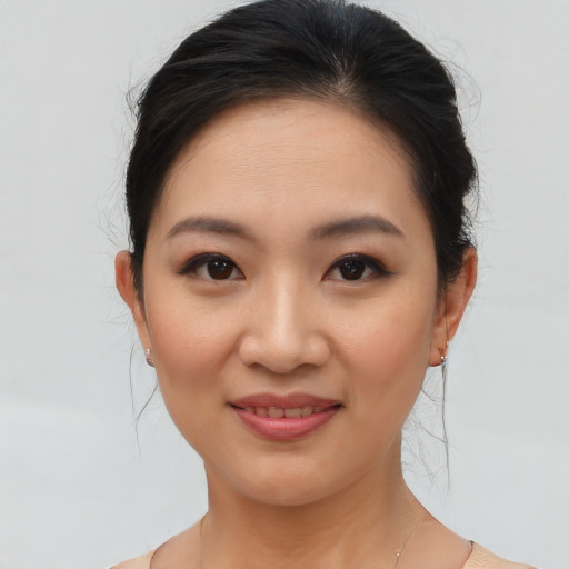 Joyful asian young-adult female with medium  brown hair and brown eyes