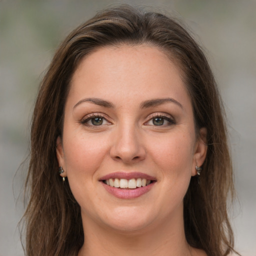 Joyful white young-adult female with medium  brown hair and green eyes