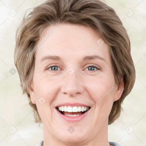 Joyful white young-adult female with medium  brown hair and green eyes