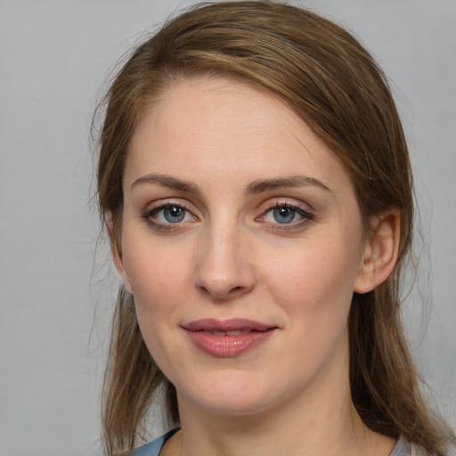 Joyful white young-adult female with medium  brown hair and grey eyes