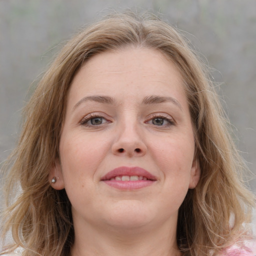 Joyful white young-adult female with medium  brown hair and blue eyes