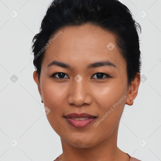 Joyful asian young-adult female with short  black hair and brown eyes