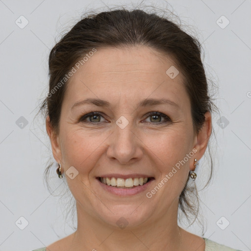 Joyful white adult female with medium  brown hair and grey eyes