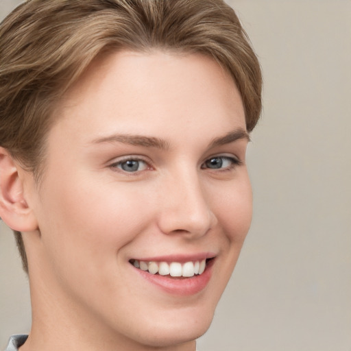 Joyful white young-adult female with short  brown hair and grey eyes