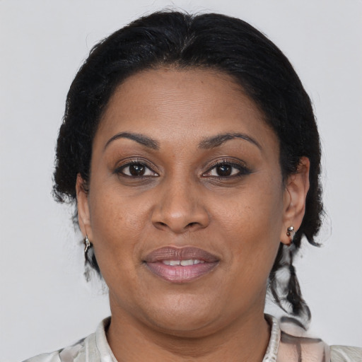 Joyful black adult female with medium  brown hair and brown eyes