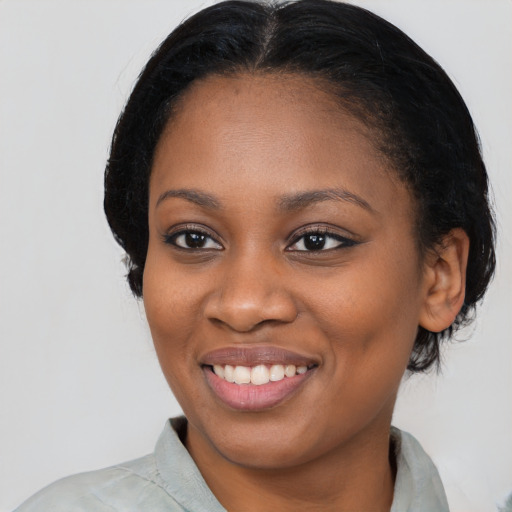 Joyful black young-adult female with medium  black hair and brown eyes