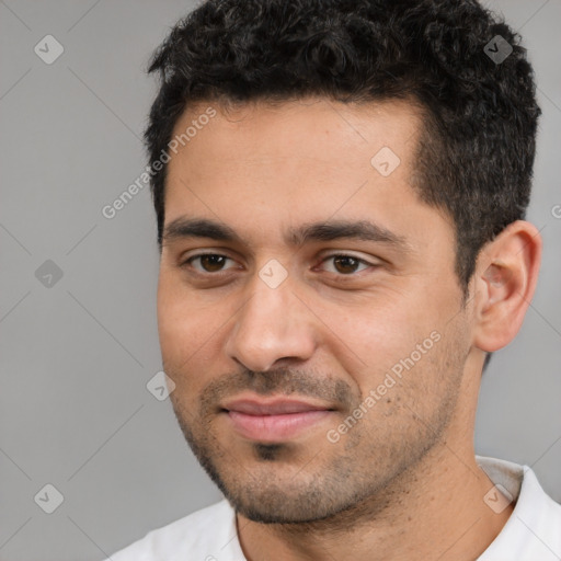 Joyful white young-adult male with short  black hair and brown eyes