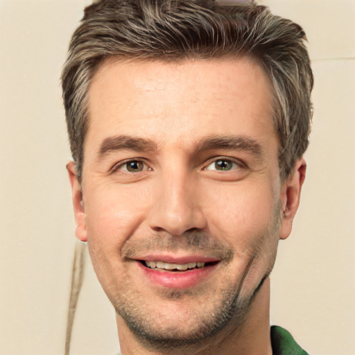 Joyful white young-adult male with short  brown hair and green eyes