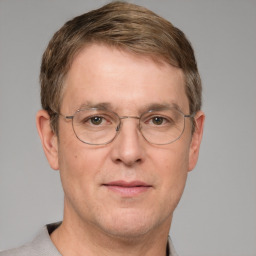 Joyful white adult male with short  brown hair and grey eyes