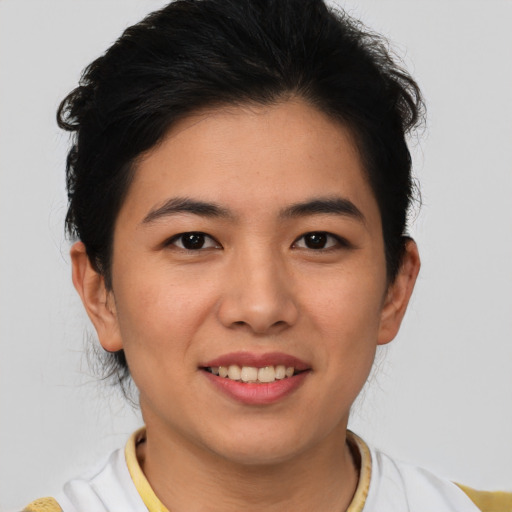Joyful asian young-adult female with short  brown hair and brown eyes