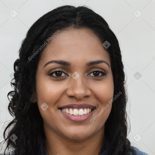 Joyful black young-adult female with long  brown hair and brown eyes