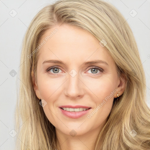 Joyful white young-adult female with long  brown hair and blue eyes