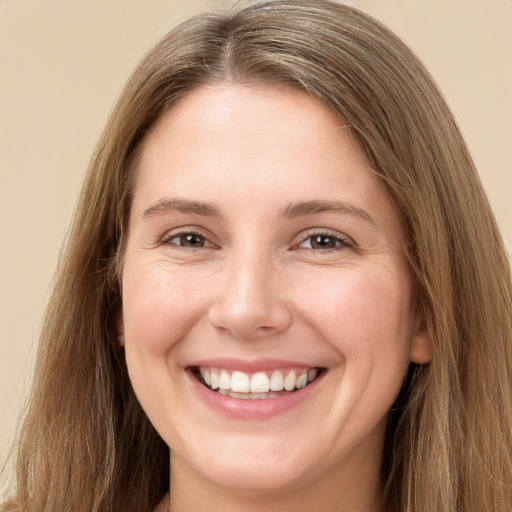 Joyful white young-adult female with long  brown hair and green eyes