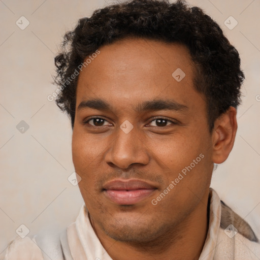 Joyful black young-adult male with short  brown hair and brown eyes