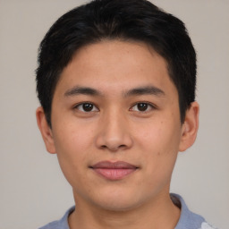 Joyful asian young-adult male with short  brown hair and brown eyes