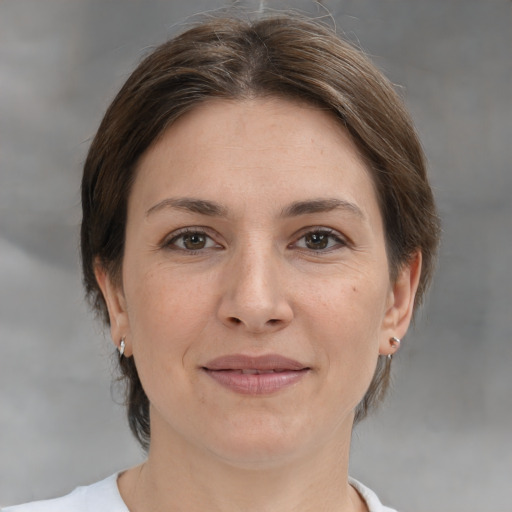 Joyful white young-adult female with medium  brown hair and brown eyes