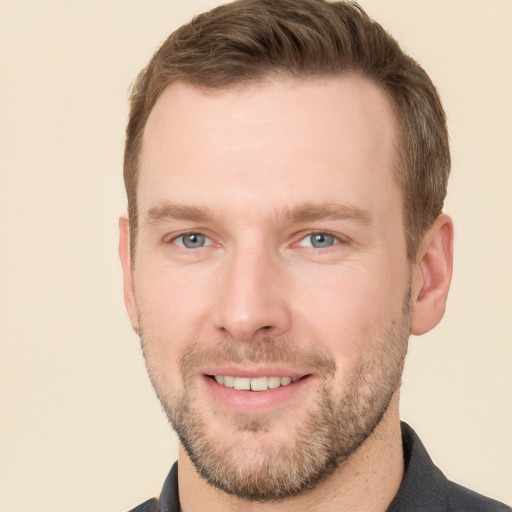 Joyful white young-adult male with short  brown hair and grey eyes