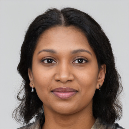 Joyful black young-adult female with medium  black hair and brown eyes
