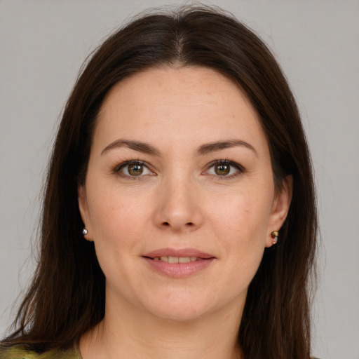 Joyful white young-adult female with long  brown hair and brown eyes