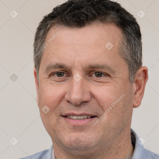 Joyful white adult male with short  brown hair and brown eyes