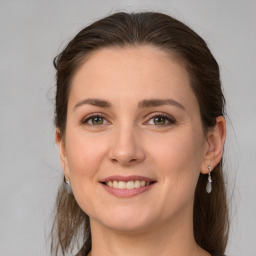 Joyful white young-adult female with medium  brown hair and grey eyes