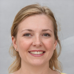 Joyful white young-adult female with medium  brown hair and blue eyes