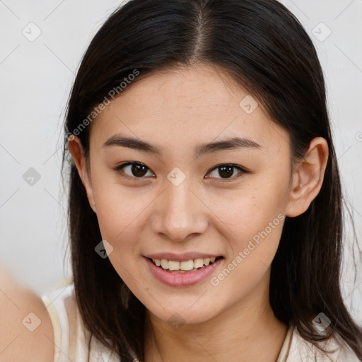 Joyful white young-adult female with long  brown hair and brown eyes