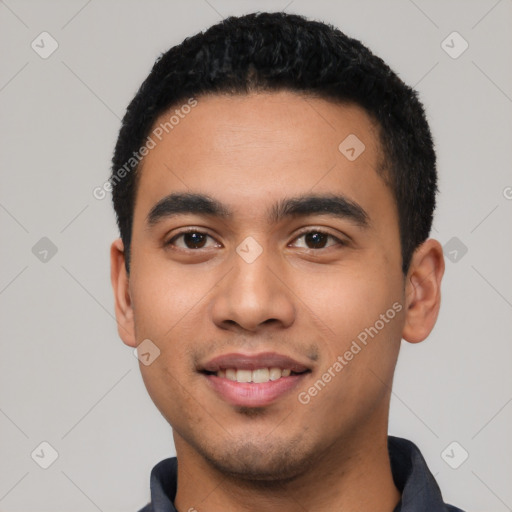 Joyful latino young-adult male with short  black hair and brown eyes