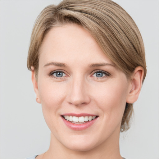 Joyful white young-adult female with medium  brown hair and grey eyes