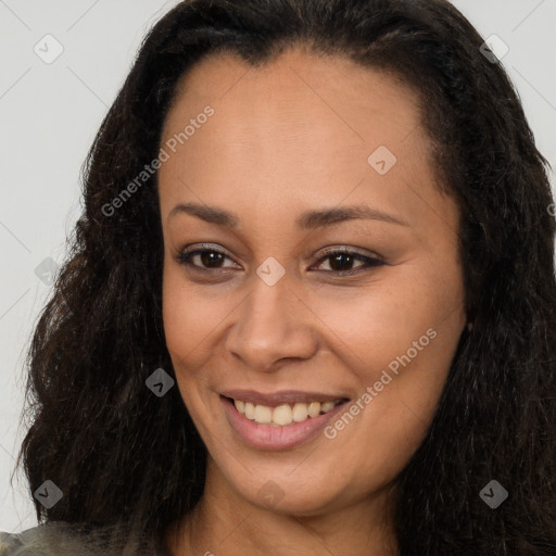 Joyful black young-adult female with long  brown hair and brown eyes