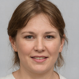 Joyful white adult female with medium  brown hair and grey eyes