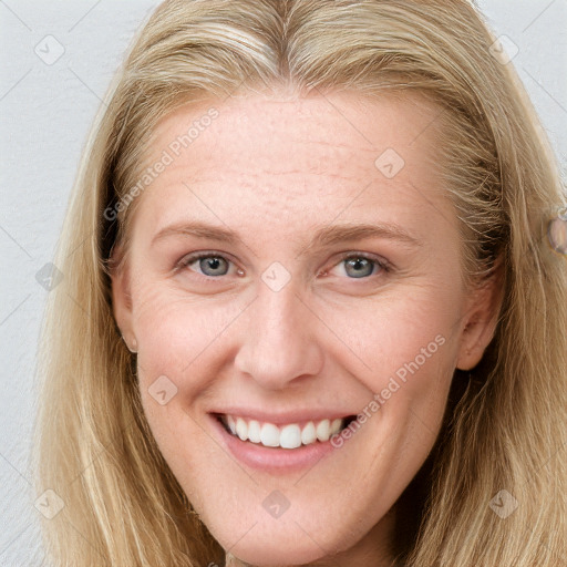 Joyful white young-adult female with long  brown hair and blue eyes