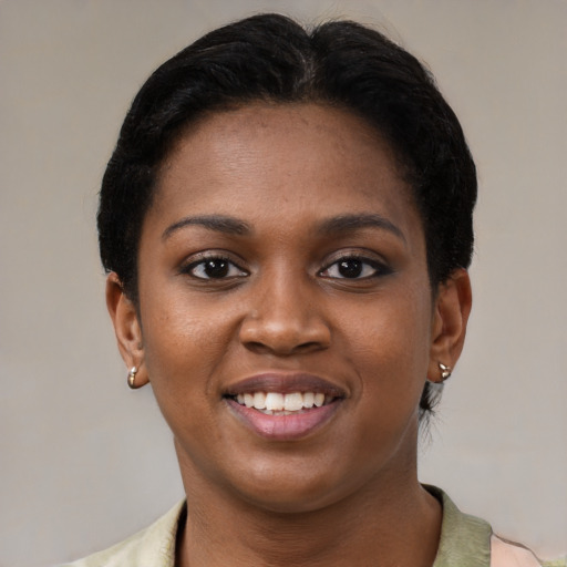 Joyful black young-adult female with short  brown hair and brown eyes