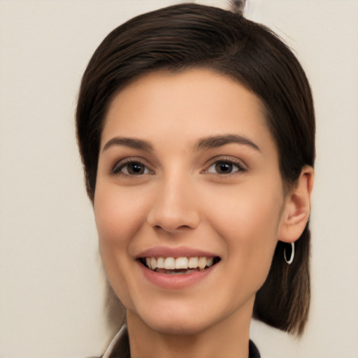 Joyful white young-adult female with medium  brown hair and brown eyes