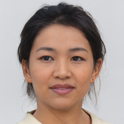 Joyful asian young-adult female with medium  brown hair and brown eyes