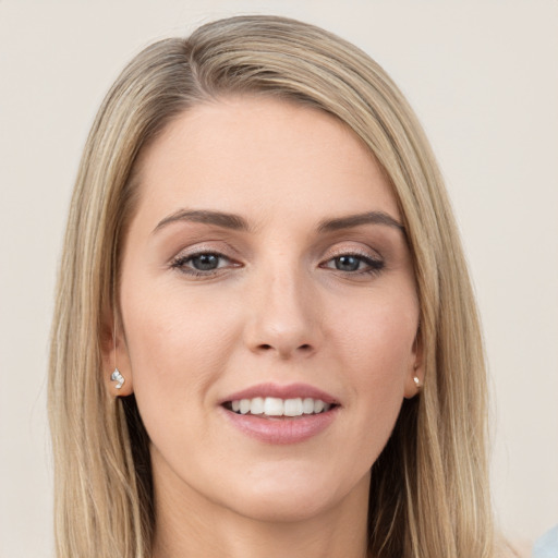 Joyful white young-adult female with long  brown hair and green eyes