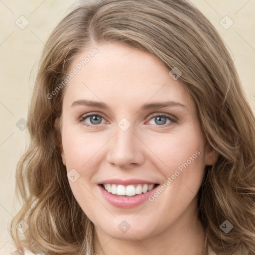 Joyful white young-adult female with long  brown hair and green eyes