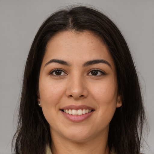 Joyful latino young-adult female with long  brown hair and brown eyes