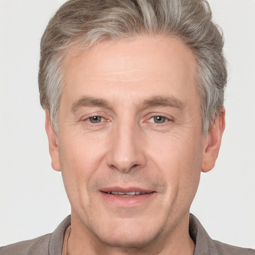 Joyful white adult male with short  brown hair and grey eyes