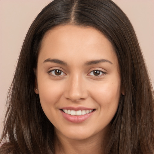 Joyful white young-adult female with long  brown hair and brown eyes