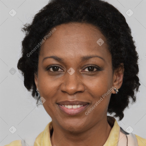 Joyful black adult female with medium  brown hair and brown eyes