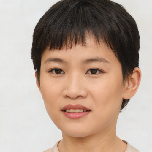 Joyful asian child female with short  brown hair and brown eyes