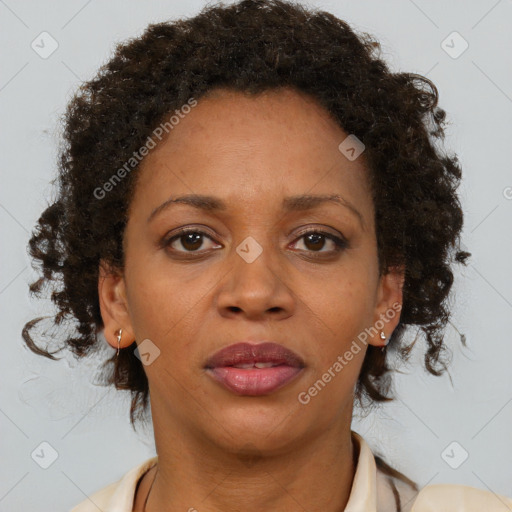 Joyful black adult female with short  brown hair and brown eyes