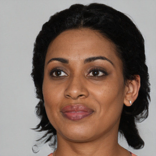 Joyful black adult female with medium  black hair and brown eyes