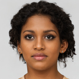 Neutral black young-adult female with medium  brown hair and brown eyes